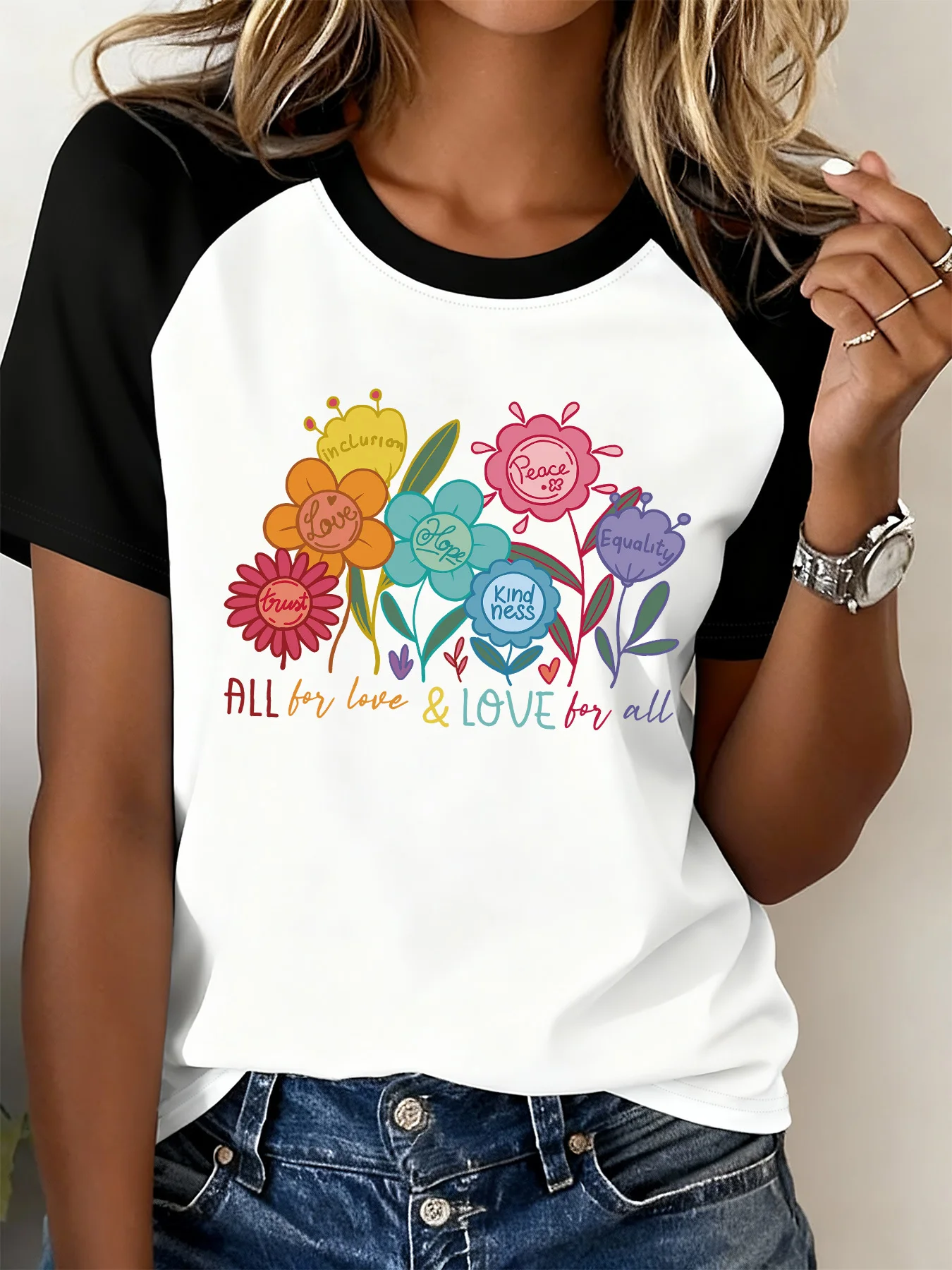 Fashionable T-Shirt in Black and White, Color-Blocked with Contrasting Raglan Sleeves and Floral Letter Print, Conveying Positive Energy of Love and Peace