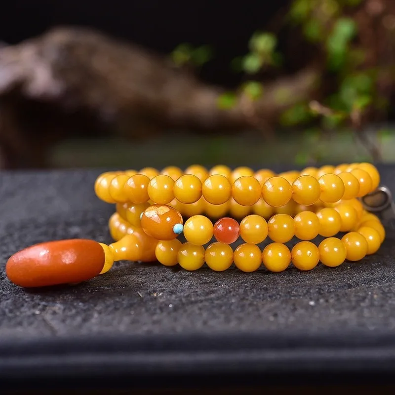 Natural with three strands featuring a rich golden-yellow amber color and 925 silver accents The bracelet is