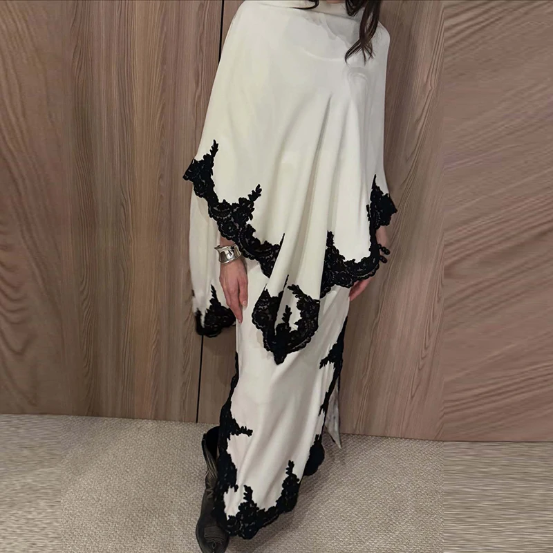 

Элегантный комплект из 2 предметов: топ с кружевной вышивкой, асимметричным вырезом и рукавами-шалью, а также длинная юбка. Женский повседневный свободный костюм из однотонной ткани.