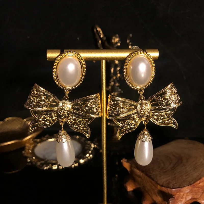 

Delicate and elegant bow earrings Gold plated water drop pearl drop earrings Advanced design elegant temperament earrings