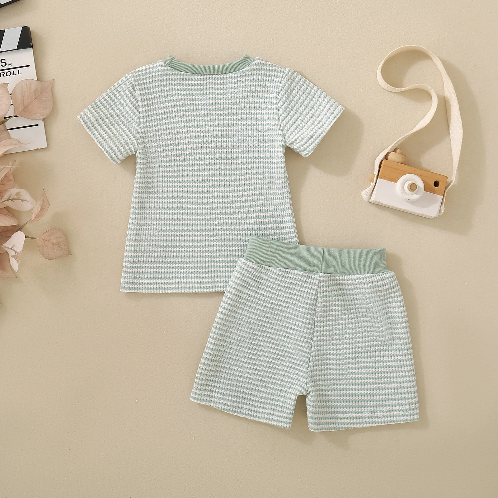 Summer unisex baby and toddler set comprising a light green striped short-sleeved top with bird embroidery and matching shorts