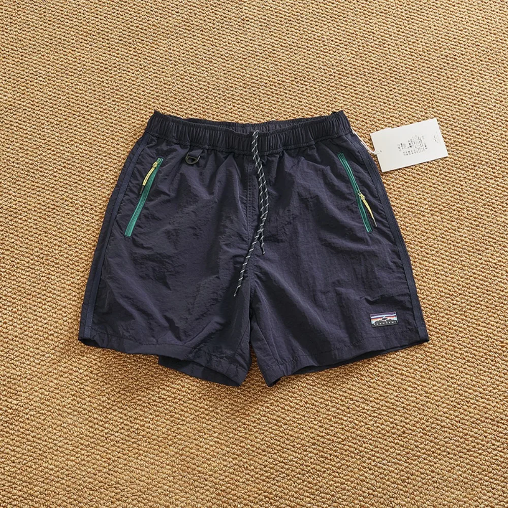 กางเกงขาสั้นแห้งเร็วกลางแจ้งฤดูร้อนสําหรับกางเกงกลางกางเกงแบรนด์แฟชั่นถนนสูงของผู้ชาย