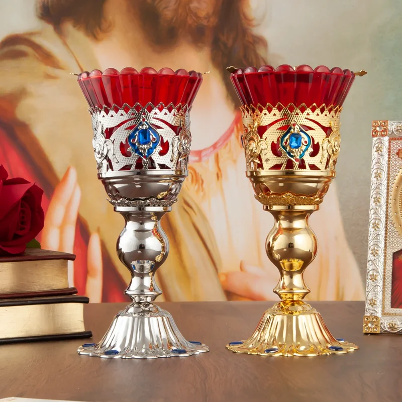 

Gold metal church candlestick with red glass