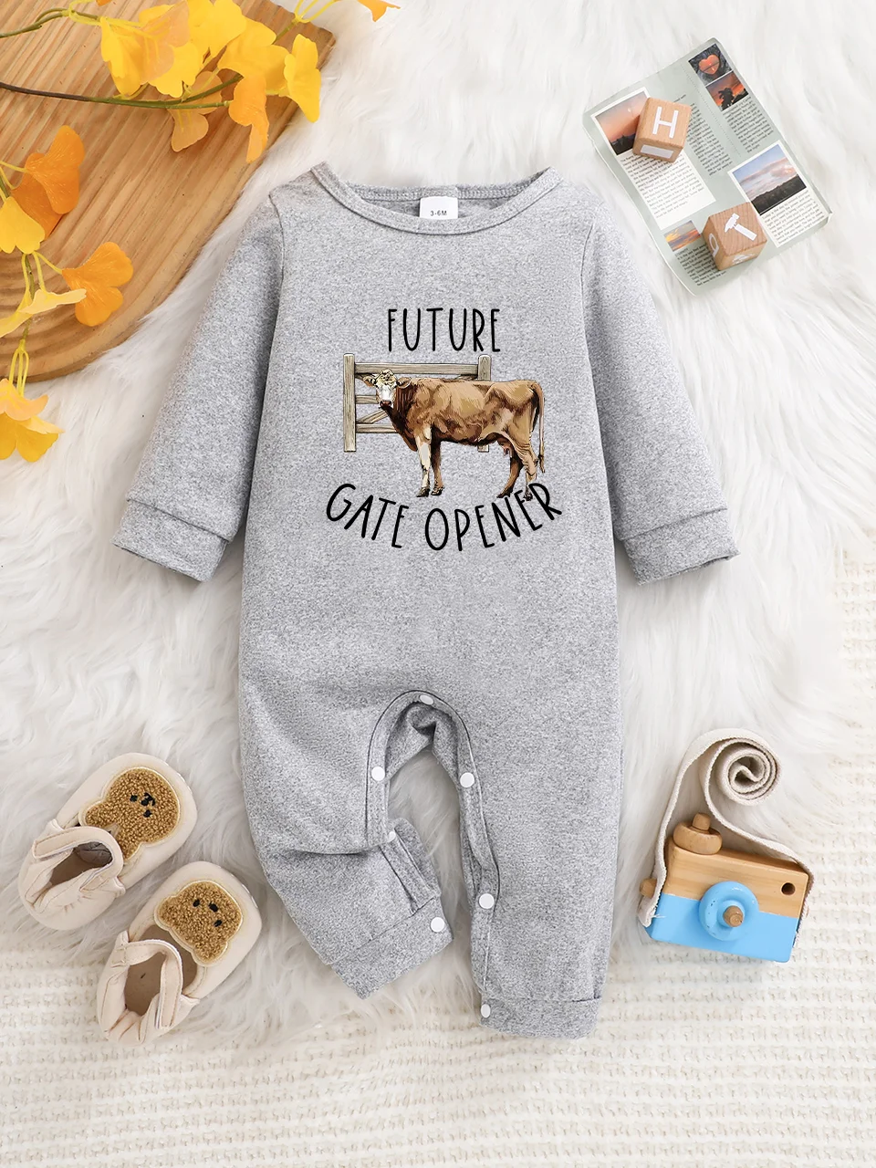 A baby long-sleeved onesie with interesting letter prints. It features a buttoned design for easy putting on and taking off