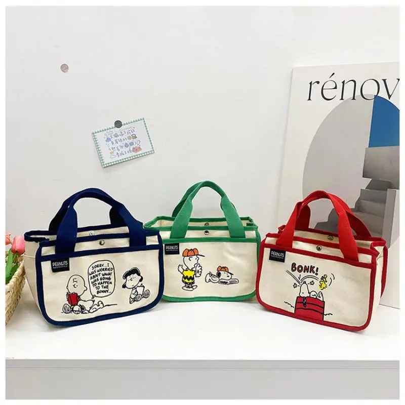 

MINISO Kawaii Anime Snoopy New Large Capacity Bento Canvas Bag Cute Cartoon Multi Functional Hand-Held Sail Bag Toys for Kids