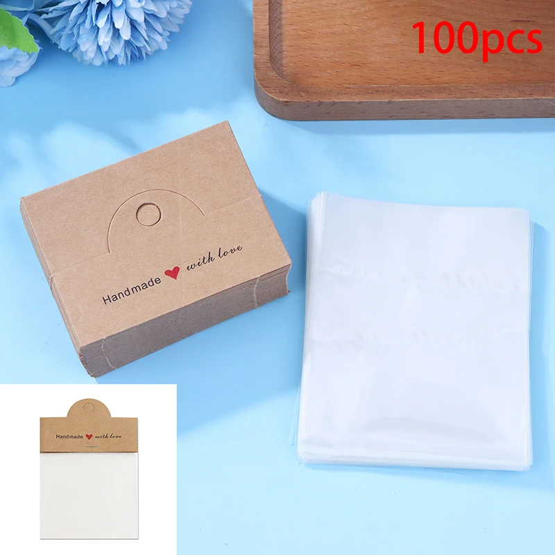 

Набор для демонстрации украшений ручной работы [YU]200: 100 элегантных прозрачных пакетов + 100 карточек с надписью "Handmade With Love" для демонстрации браслетов, серег и других украшений.