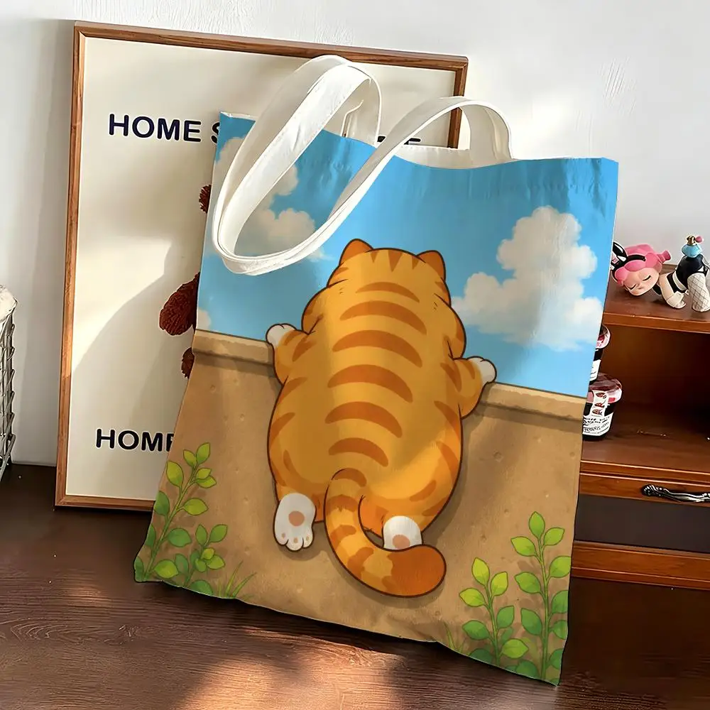 A chubby orange cat Storage Bags Canvas bags are suitable for going to class, shopping, gifts, and commuting
