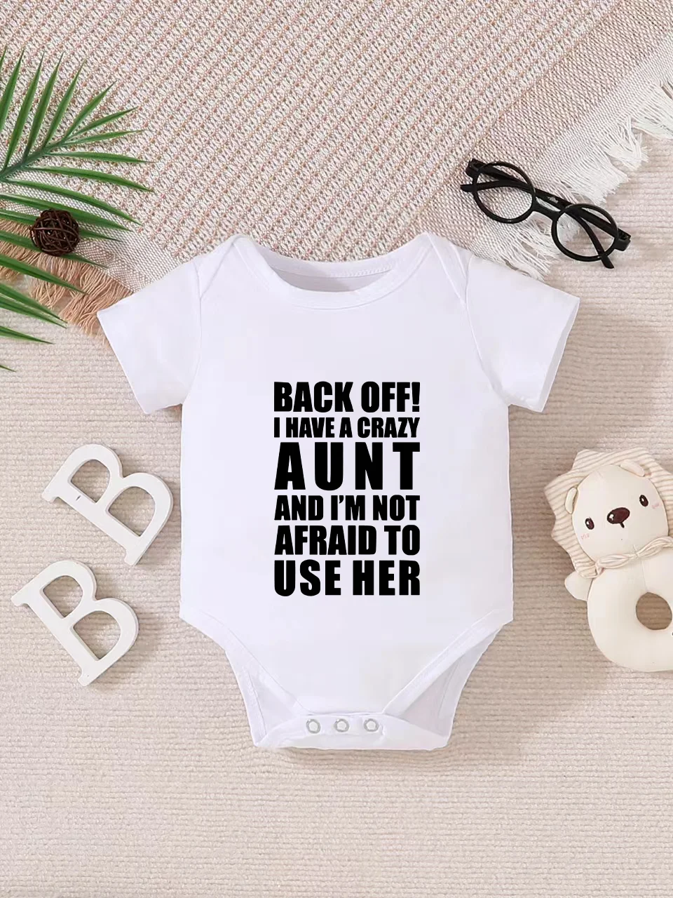 Playful letter-printed baby short-sleeve triangle bodysuit. Button closure for easy dressing, machine washable