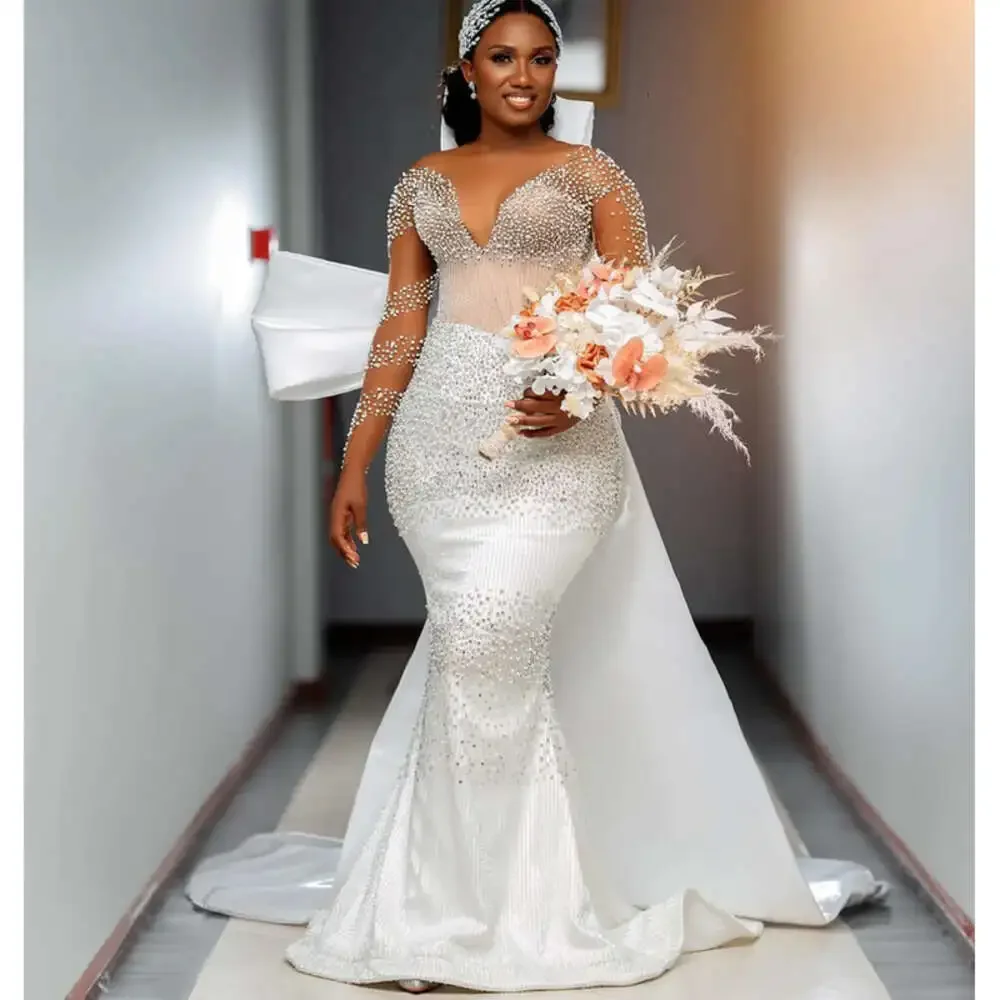 Maßgeschneidertes Meerjungfrau-Brautkleid mit durchsichtigem Ausschnitt, Perlenkristallen und kaskadierenden Rüschen, Schleppe und abnehmbarer Schleife