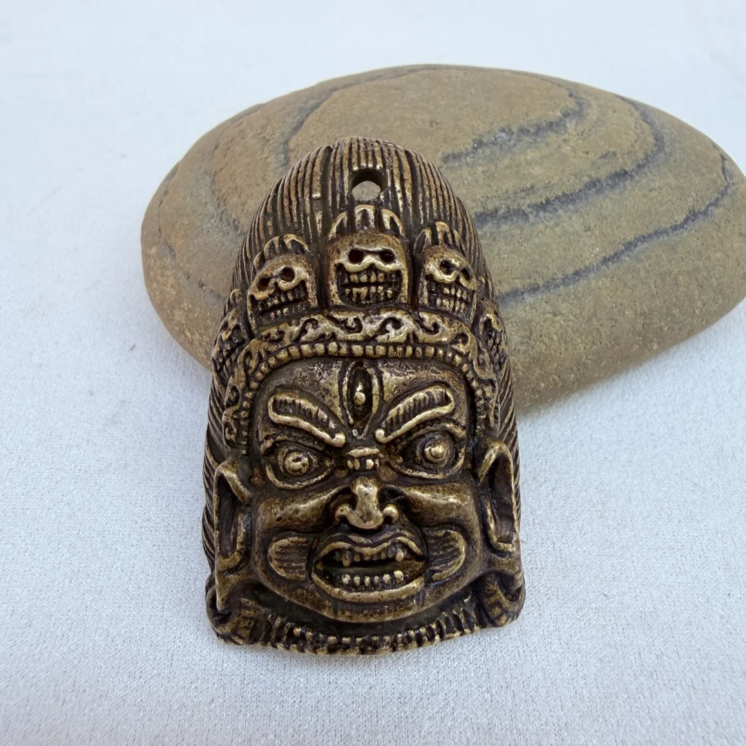 

Tibetan Brass Mahakala Head Pendant, Handcrafted Protective Amulet with Antique Patina, Spiritual Dharma Charm