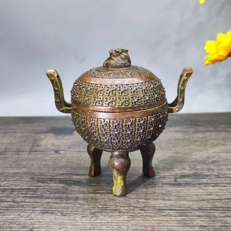 Vintage copper-colored patinaed incense burner with a double-eared lid, featuring a three-legged tripod and a 