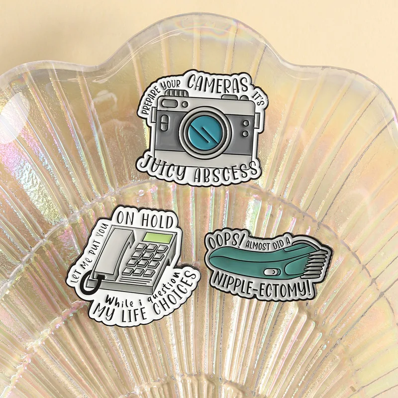 Retro Cartoon Camera Hair Shaving Telephone Brooch Pins OOPS! Always Did A Nipple-Ectomy Letter Enamel Lapel Pin Accessory On Ba
