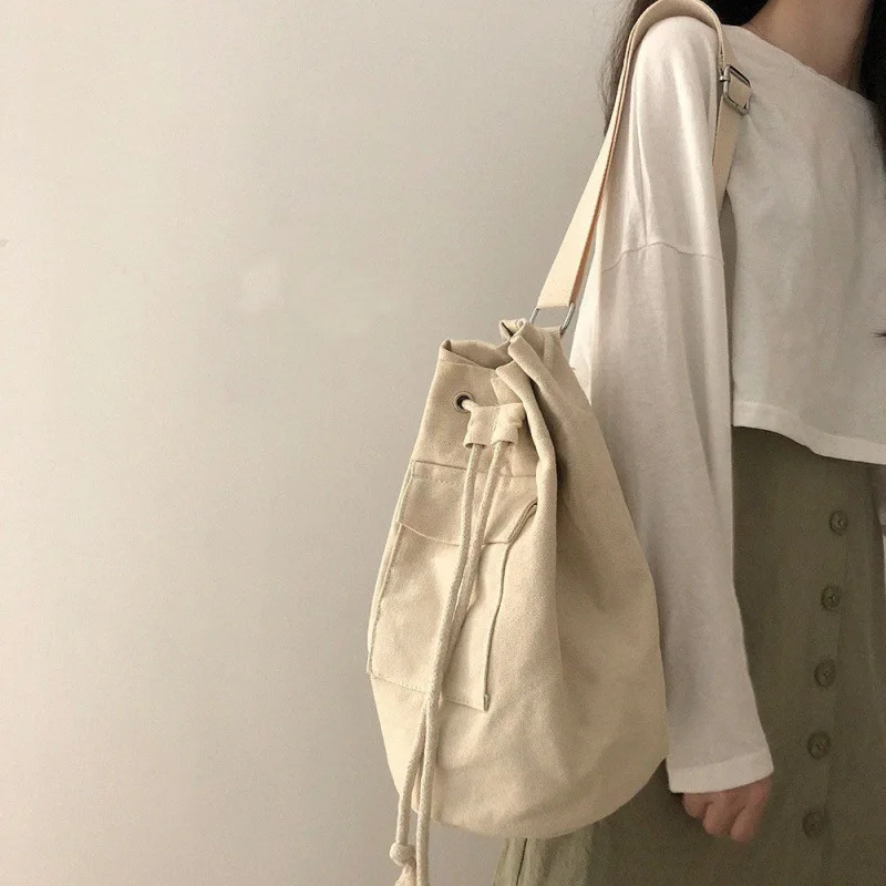 Large capacity bucket bag Korean version Ins early autumn pocket canvas drawstring diagonal shoulder bag for men and women