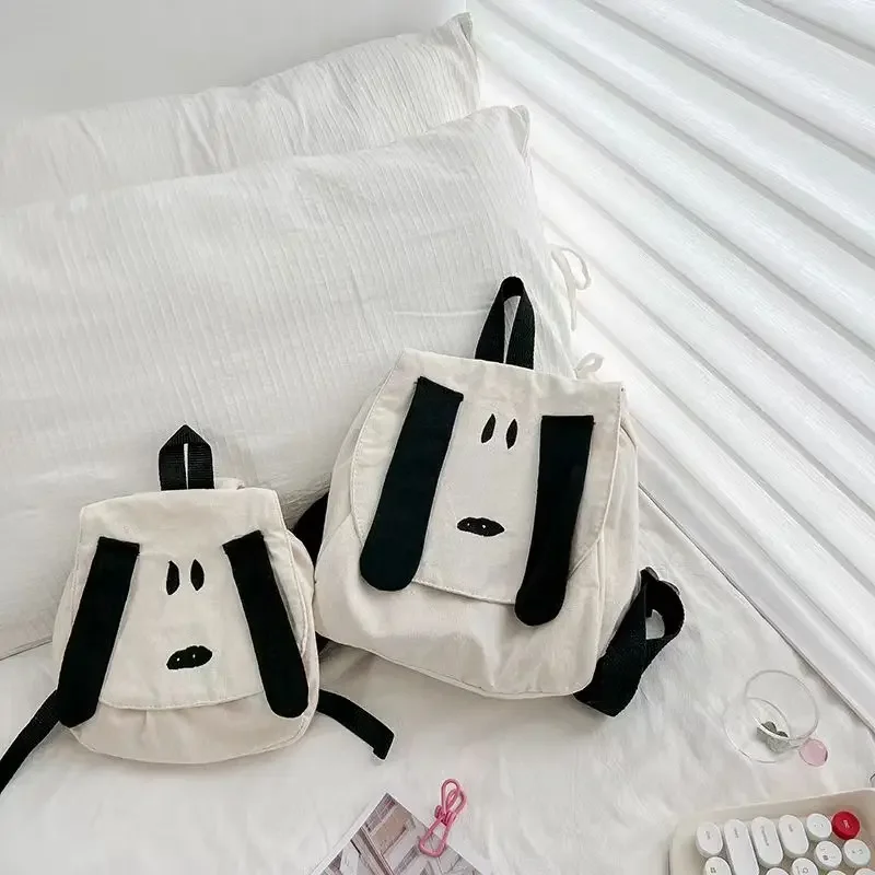 Snoopy น่ารักการ์ตูนกระเป๋าเป้สะพายหลังผ้าใบแบบพกพากระเป๋าเป้สะพายหลังเด็กการ์ตูนอุปกรณ์ต่อพ่วงเพื่อนเด็กวันหยุดของขวัญ