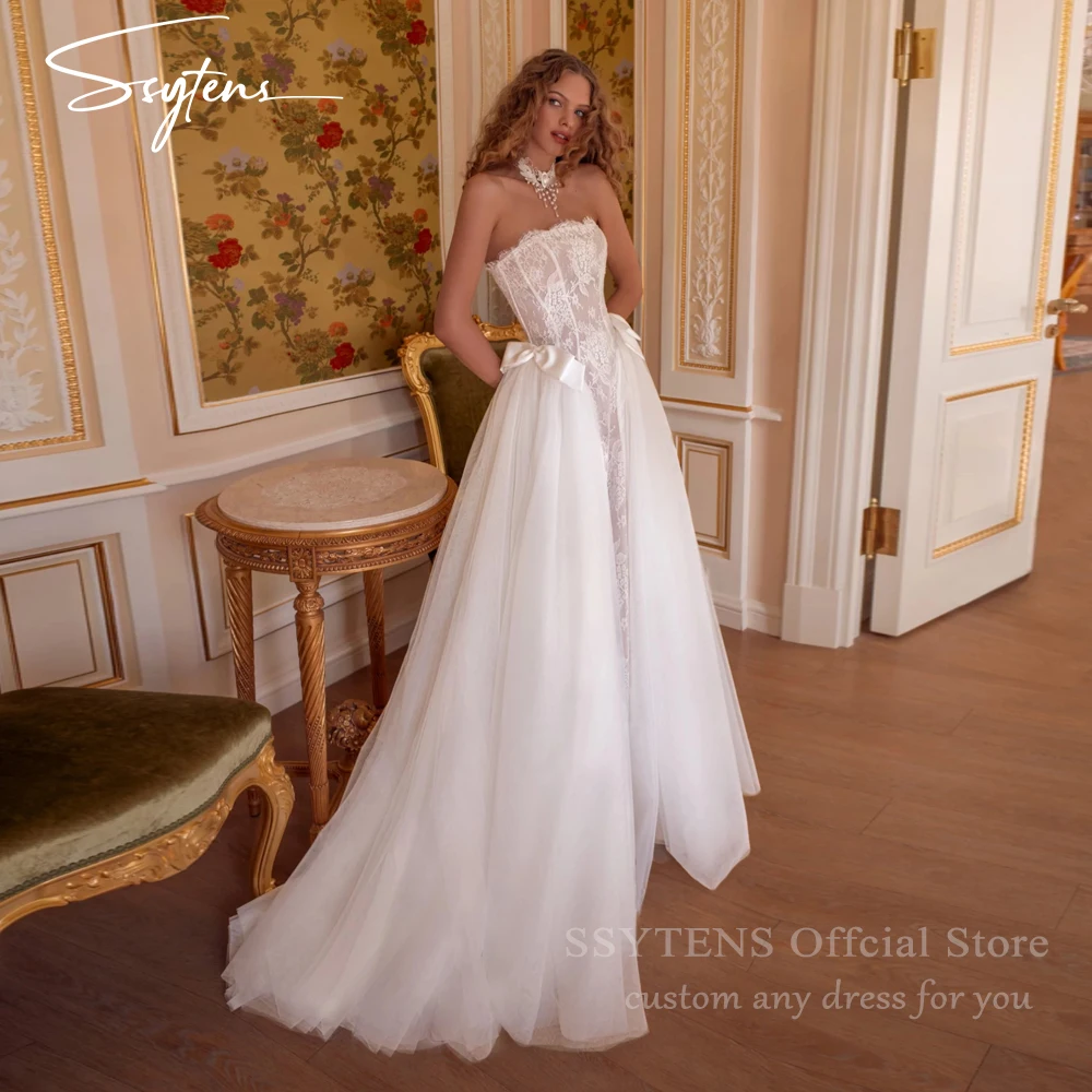 فساتين زفاف SSYTENS المصنوعة من الدانتيل بدون حمالات، مزينة بفيونكة بيضاء، أنيقة للأميرة، فساتين زفاف رسمية طويلة لعام 2026 #1