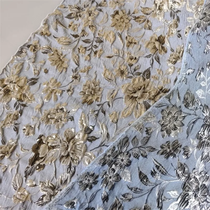 This is a fabric for an elegant dress coat with textured made of dyed embossed gold thread flower jacquard