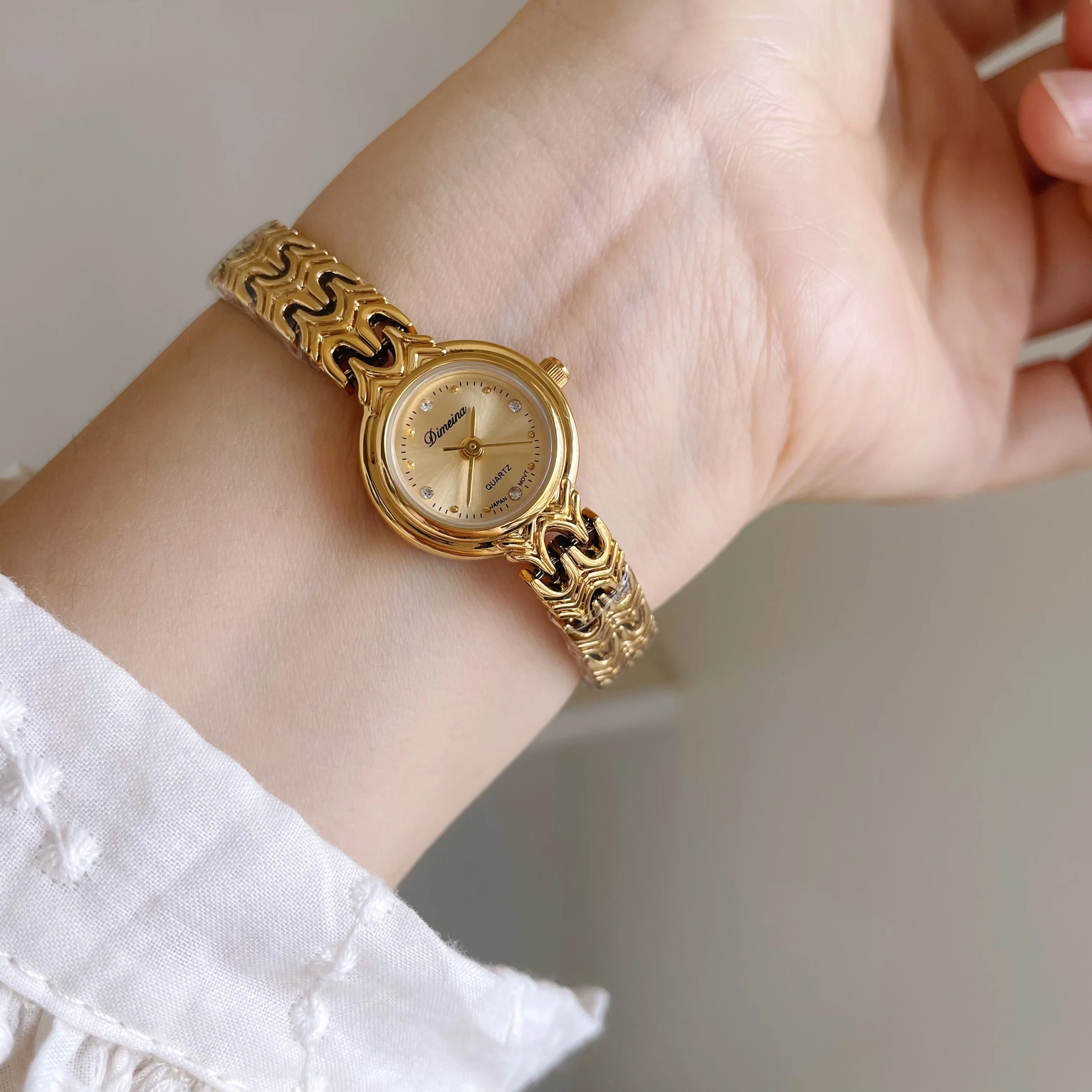 

Mini gold retro-style watch with a small dial and openwork strap; a luxurious quartz watch for women; a perfect gift for women.