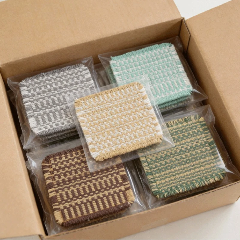 Vintage-inspired, tassel-trimmed woven coasters. checkered square fabric trivets, perfect for coffee, tea, and more