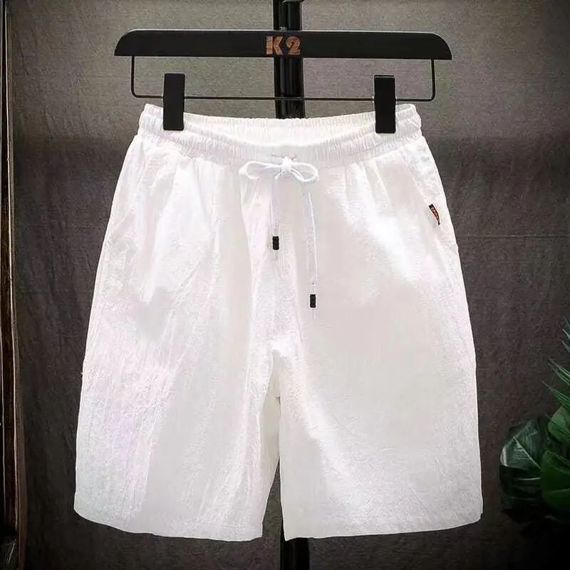 Pantalones cortos de lino para hombre, pantalón holgado de marca a la moda, con flores de cinco cuartos, de secado rápido, informal, para playa, Sanya, 2024