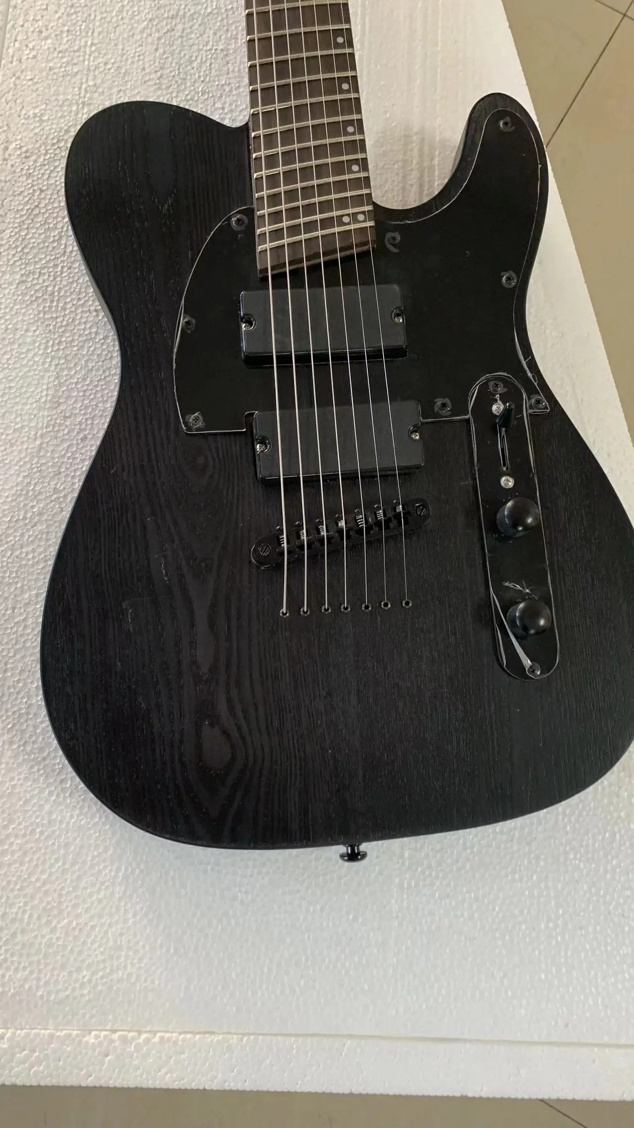 High-end custom 7-string oblique electric guitar, classic shape, transparent black ash body, active pickup, free delivery