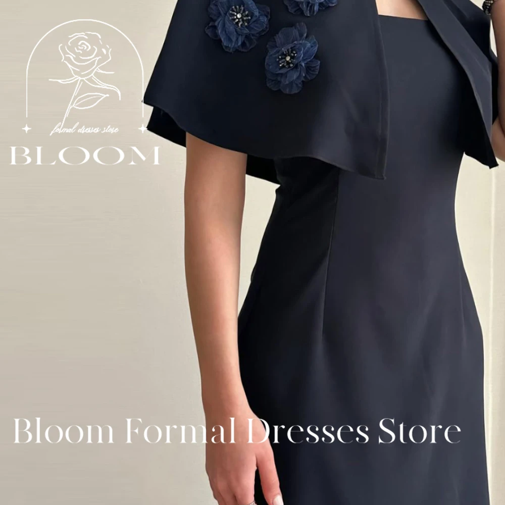 Bloom Customized Sophisticated Navy Blue Dress features a unique cape detail with decorative blue flowers. The straight neckline