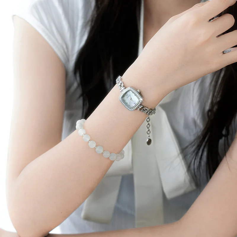 This petite mother-of-pearl square watch for women exudes sophistication with its delicate bracelet and versatile style.