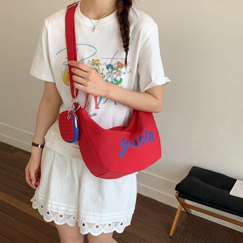 

College-style letter print canvas bag for women in summer2026New trendy fashion large-capacity saddle bag shoulder tote bag