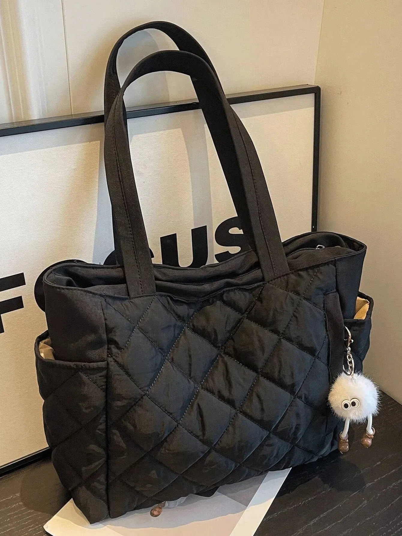 

Black Quilted Large Tote Bag with Dual Handles and Fluffy Charm Pendant
