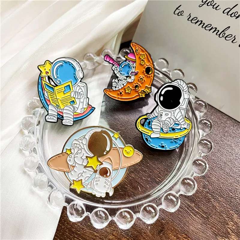 Cute Reading Newspaper Astronaut Enamel Brooch Cartoon Meteor Universe Spaceman Alloy Badge Women Men Clothes Bag Gift Jewelry