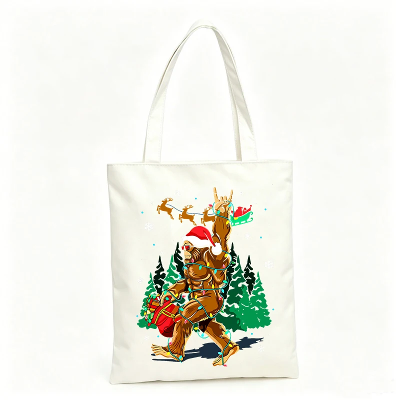 Women's canvas tote bag with festive bigfoot and Santa graphic, ideal for holiday shopping and winter outings