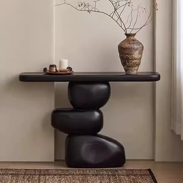 

Carbonized black rock log end view table against the wall entrance table