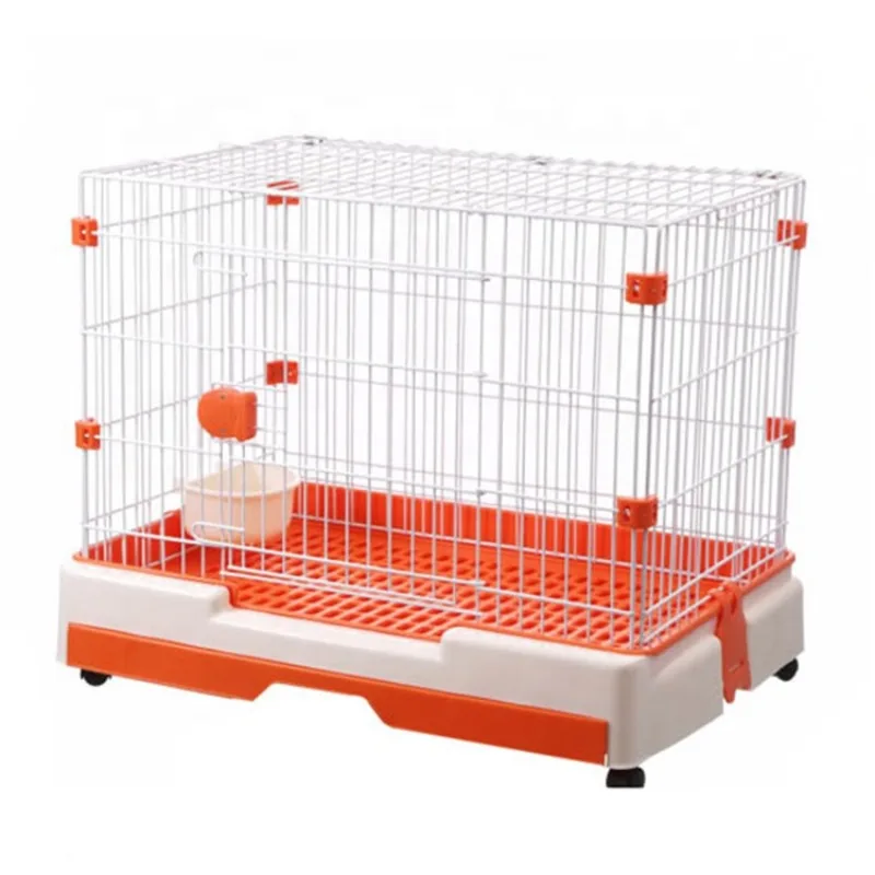 Pink/orange/brown/green wire dog cage pointing roof