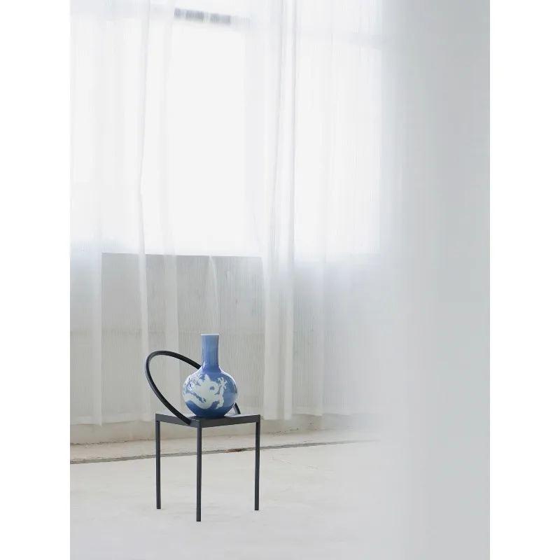 The study is equipped with a large vase, all handmade sky blue glaze engraved with dragon patterns and filled with white
