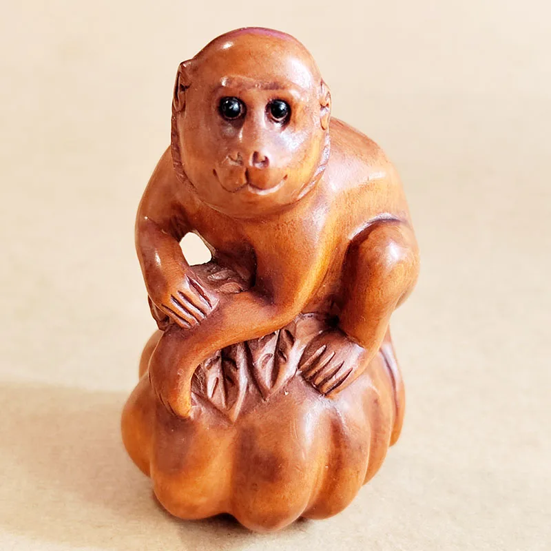 

Q4781 - 2" Hand Carved Boxwood Netsuke: Monkey on Pumpkin