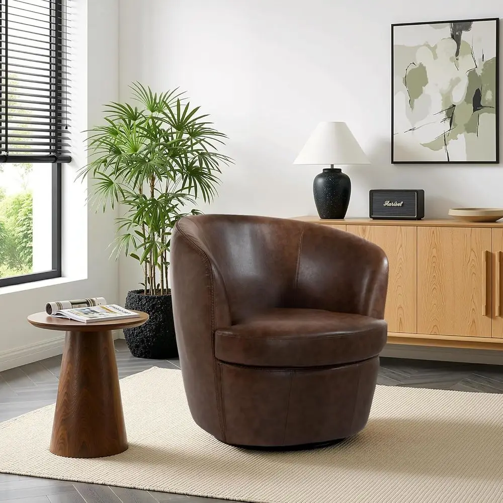

Вращающееся кожаное кресло-бочонок с мягкими подлокотниками и металлическим основанием для гостиной