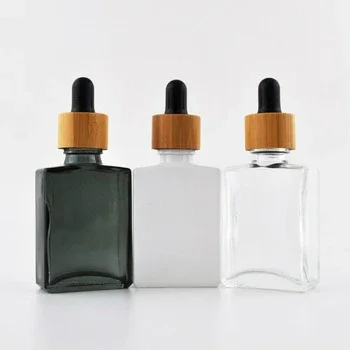 

Custom engraving logo eco friendly falt shoulder cosmetic skincare packaging container CBD oil glass dropper bottlewithbamboolid