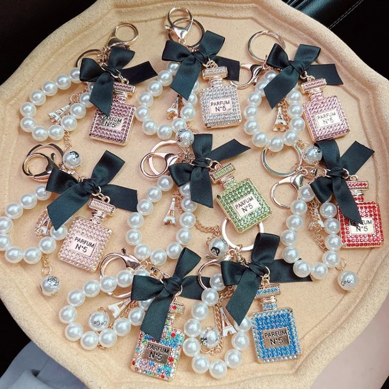 Alloy diamond inlaid bow shaped perfume bottle key chain creative pearl chain bag pendant exquisite key chain image 4