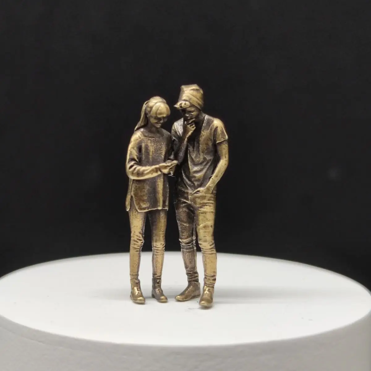 Brass miniature figurines 1/64 scale car model scene figures macro photography modern characters couple looking at phone