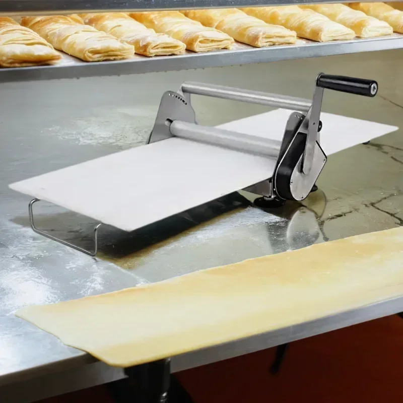 

A Mini pastry por small top hand manual pizza dough sheeter roller shelter press flattener shetter laminator machine
