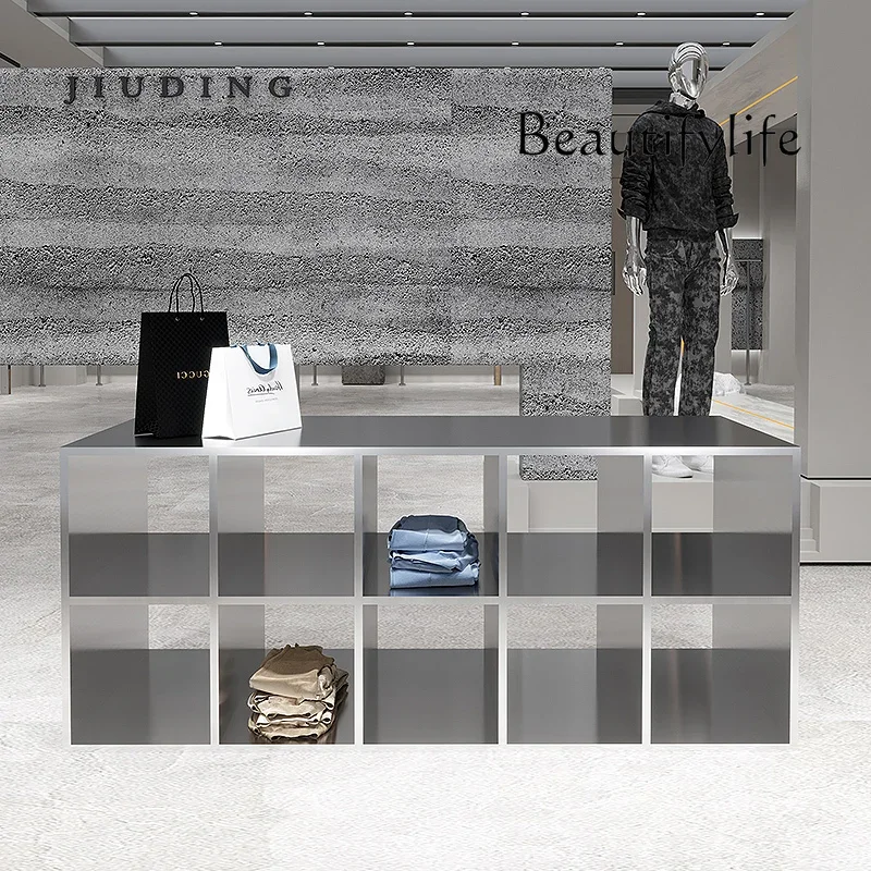 A Stainless Steel Shoes And Bags Are Placed In The Middle Of The Nakajima Table In The Clothing Store. High And Low Display Stan