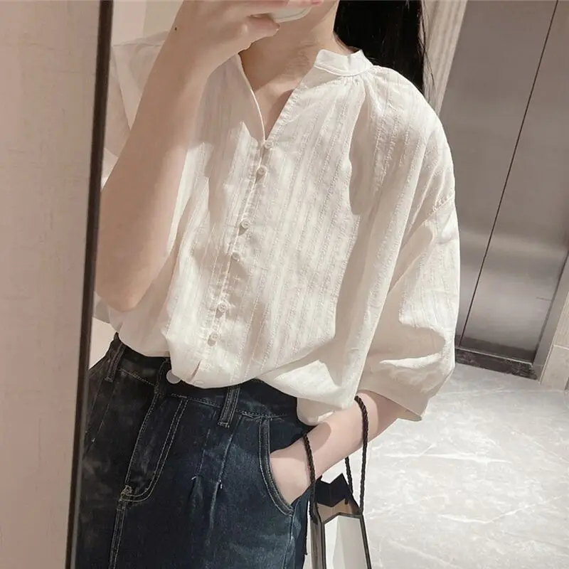 

Women White V-Neck Blouse with Textured Fabric, Half Sleeves, and Button Front Detail Loose Fit Casual Top