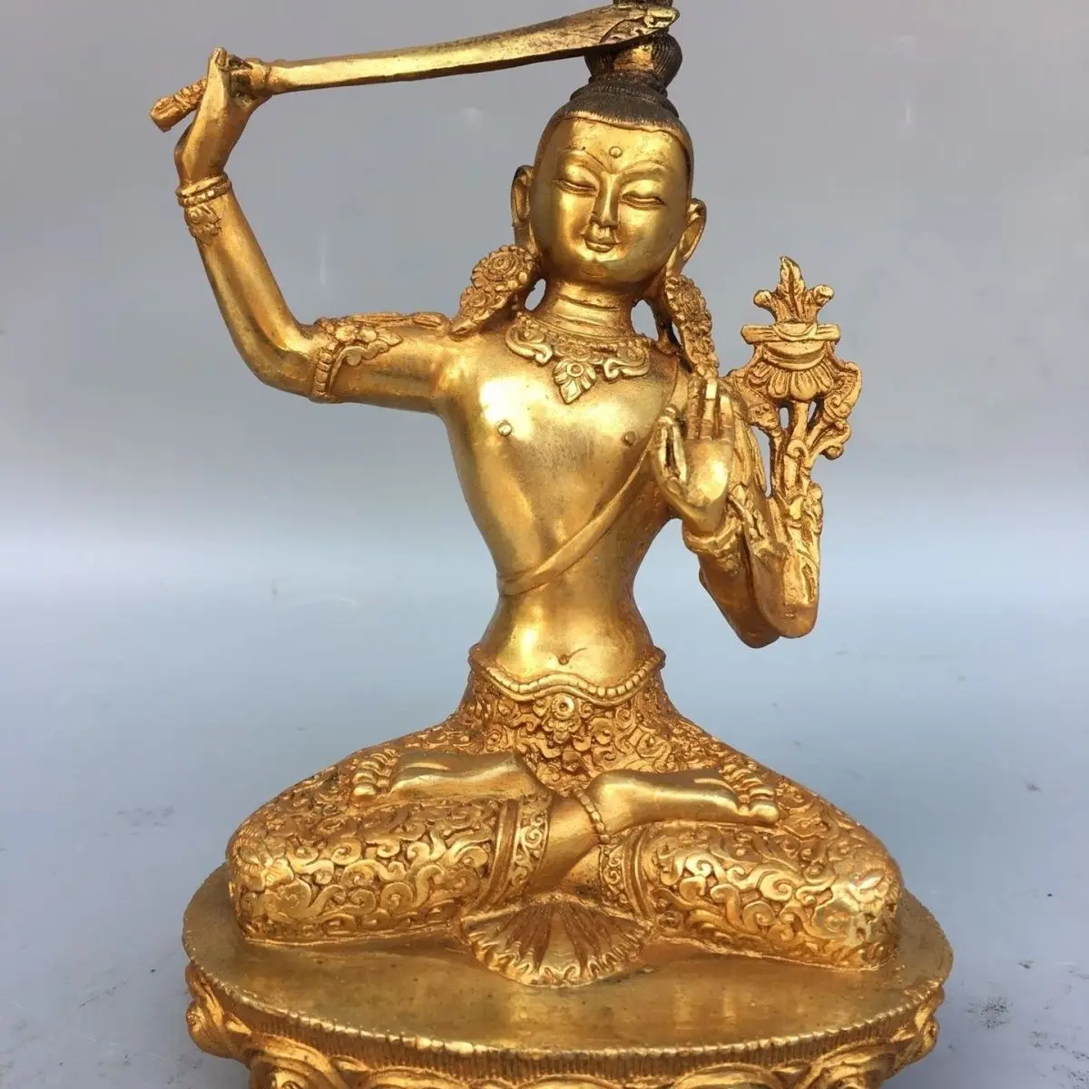 Bronze gilt Manjushri Buddha statue is 18 cm high and 13 cm wide and weighs about 1 kg