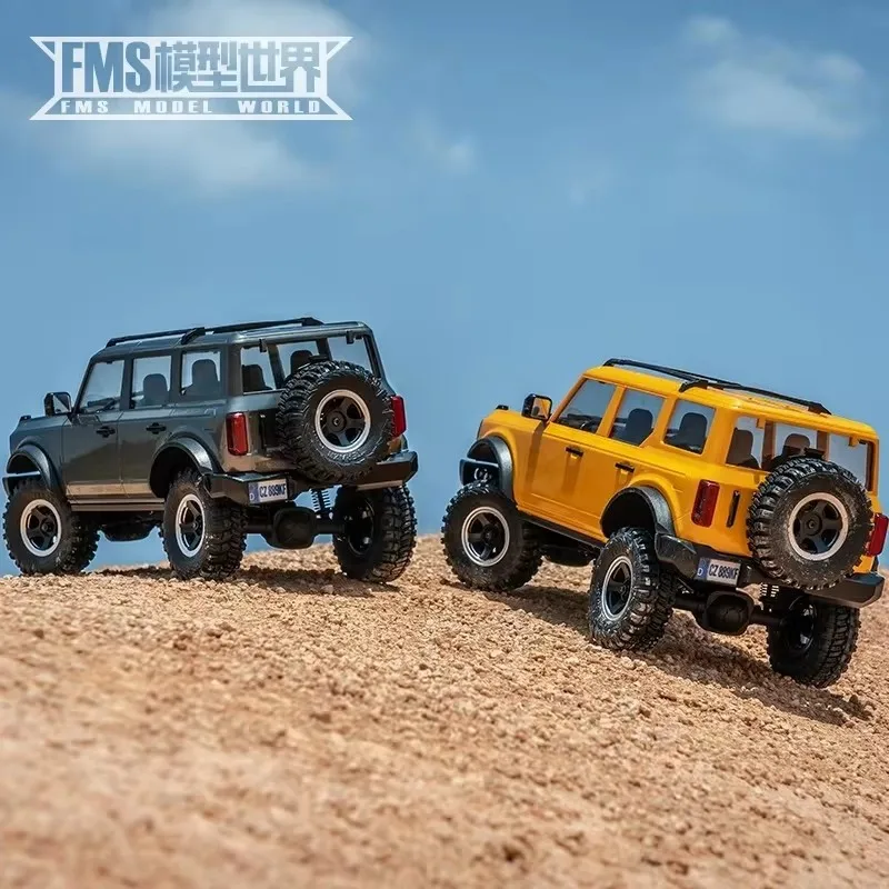 ของเล่นโมเดลจำลองเปลือกแข็งรถสำหรับปีนเขาทางวิบากแบบ FMS 1/18 Bronx Gold Rush Ford Wrangler mobil REMOTE CONTROL