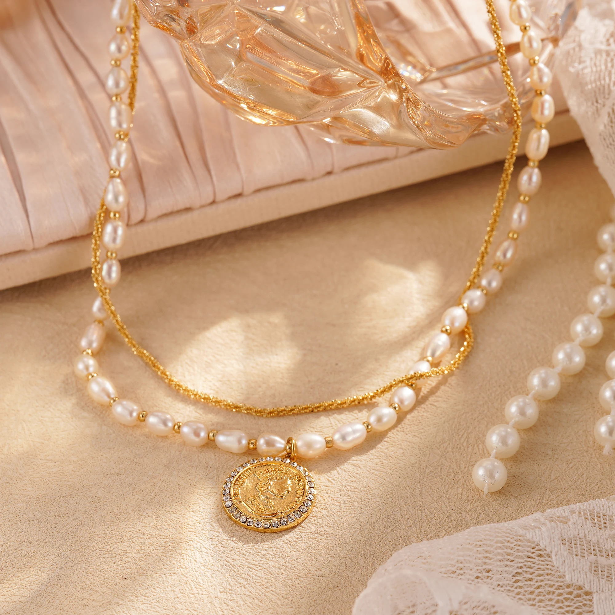 

Rustic-style double-layered pearl coin necklace with an elegant cubic zirconia pavé-set Elizabeth portrait pendant for women