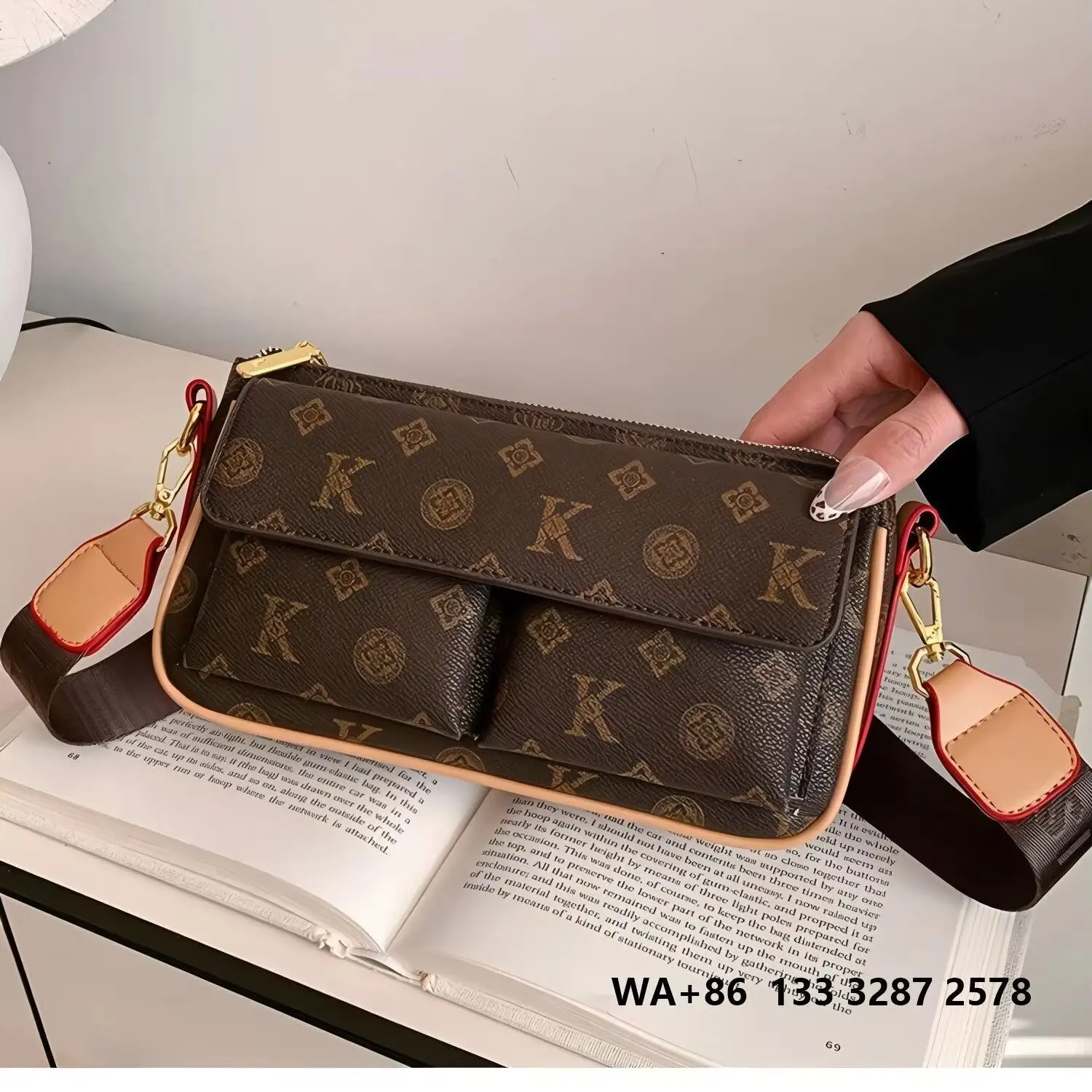 Vintage letter print mini crossbody bag with contrasting brown leather trim, double front patch pockets, wide adjustable fabric shoulder strap, and gold zipper.
