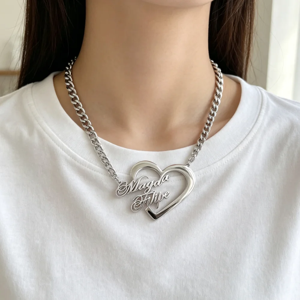 Custom gold hollow heart necklace carved with two names, personalized couple pendant with thick curb chain for romantic gifts.