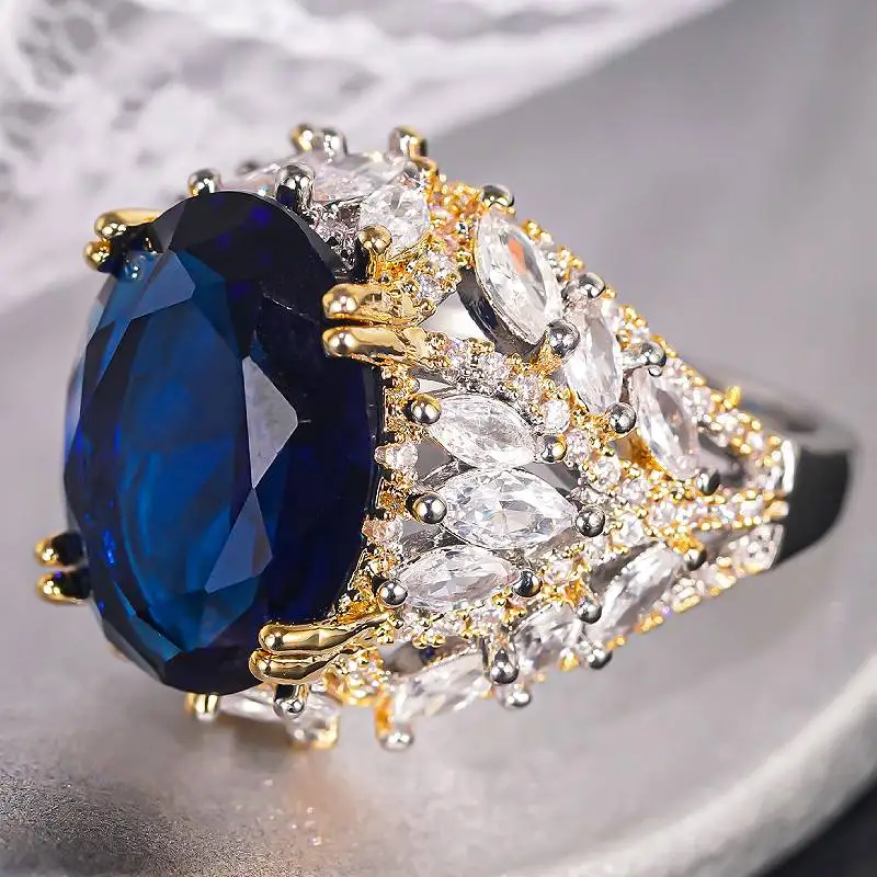 Huitan Damen-Ring in zwei Farben, wunderschön eingelegt mit brillantem blauen CZ, edles Hochzeits- und Party-Accessoire, ausgefallener, trendiger Schmuck für den Verlobungsfeierlichkeiten