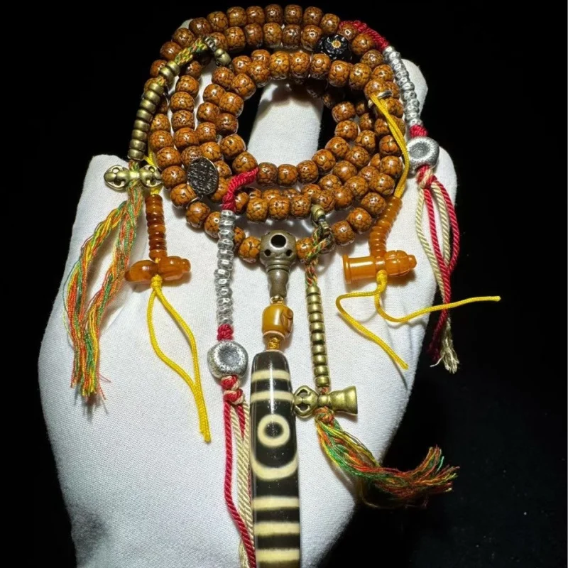 vintage star-moon multi-strand bracelet Tibetan sacred objects and two-eyed dzi beads, with a rich patina