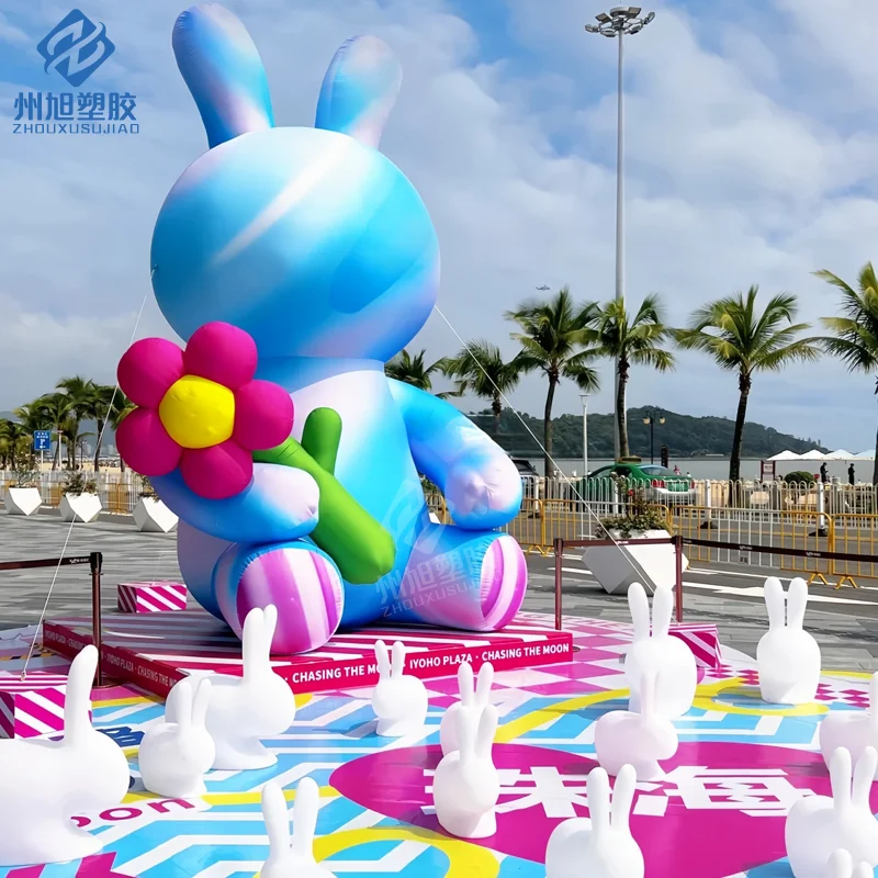 Giant inflatable colorful rabbit holding flowers, suitable for decorative props in outdoor park activities.
