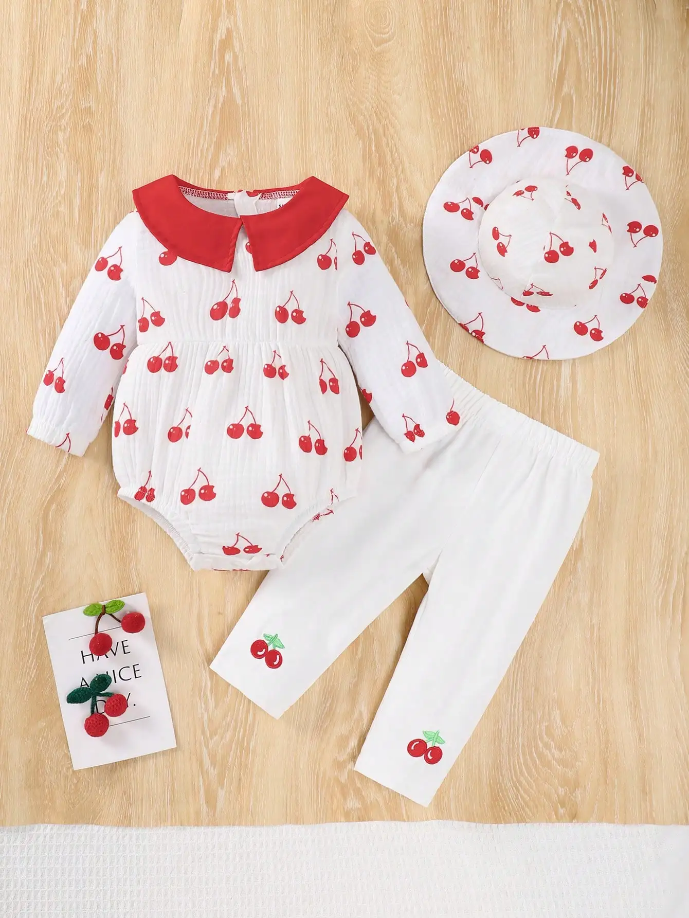 

A 3-Piece Set Of Cherry Print Long-Sleeved Climbing Triangle Pants Long Pants And A Hat For Newborns In Spring And Autumn